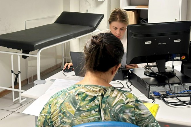 Descrição da imagem: Servidora do INSS realiza atendimento durante mutirão em Goiânia (GO). Foto: Ana Paula Ergang/ Ascom INSS.